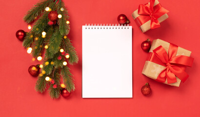 Fototapeta na wymiar Christmas gifts boxes toys blank notepad red background Festive New Year concept