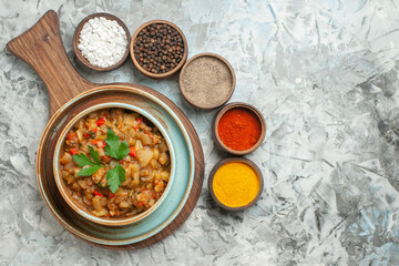 top view roasted eggplant salad in bowl different spices in bowls on grey background free space food photo