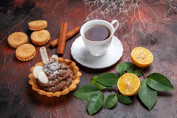 front view cup of tea with delicious little cake on dark background cookies dessert biscuit