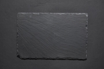 Black textured sushi slate board background with copyspace. Place for sushi, Japanese cuisine concept.