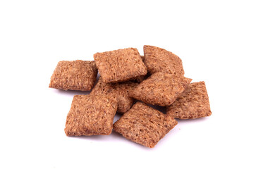 chocolate pillows for breakfast isolated on white background. Brown choco cereal pads with cream