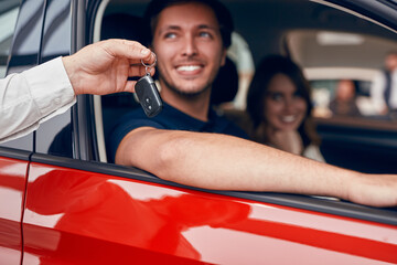 Crop dealer giving car keys to couple