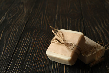Pieces of natural handmade soap on wooden background