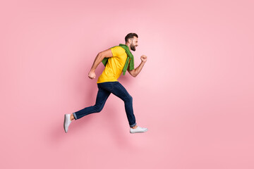 Fototapeta na wymiar Full body profile side photo of cheerful young guy run jump empty space sale excited isolated on pink color background