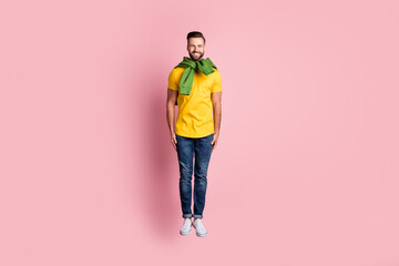 Full body photo of happy funky man jump up air wear tight jumper good mood isolated on pink color background