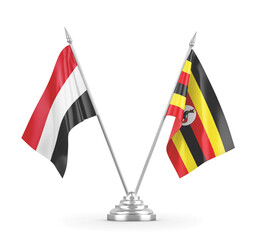 Uganda and Yemen table flags isolated on white 3D rendering