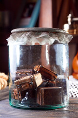 Glass jar with vintage toy suitcases. Interior decor