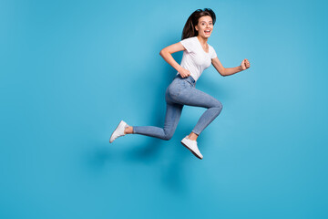 Fototapeta na wymiar Full size profile side photo of cheerful charming lady jump up run empty space sale hurry isolated on blue color background