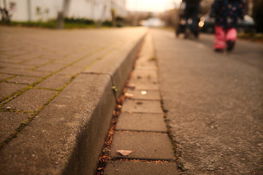 Spazieren gehen in der Abendsonne. Fu&szlig;weg und Stra&szlig;e