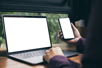 computer,cell phone blank screen mockup.hand woman work using laptop texting mobile. with white background for advertising,contact business search information on desk in cafe.marketing,design