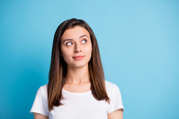 Photo of adorable thoughtful young lady wear white clothes looking empty space isolated blue color background