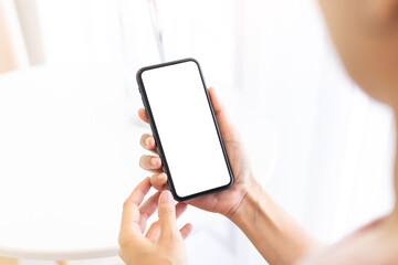 cell phone blank white screen mockup.woman hand holding texting using mobile on desk at office.background empty space for advertise.work people contact marketing business,technology