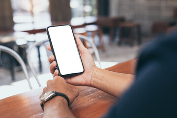 cell phone blank white screen mockup.man hand holding texting using mobile on desk at office.background empty space for advertise.work people contact marketing business,technology