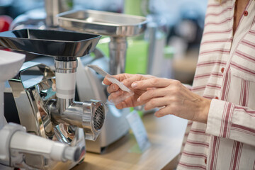 Close up picture of a woman choosing goods for kitchen