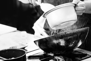 Chef cooking in a kitchen, chef at work, Black and White.