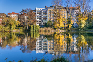 Fototapeta na wymiar Park Lietzensee and buildings on the shore of Lake Lietzen in Berlin, Germany