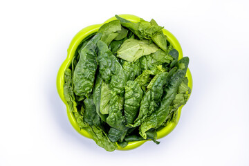Fresh spinach in a green bowl. Juicy green spinach, white background, top view