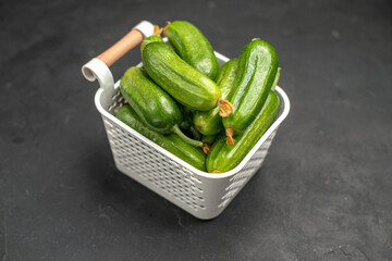 front view fresh green cucumbers inside basket on dark background salad meal food health color photo