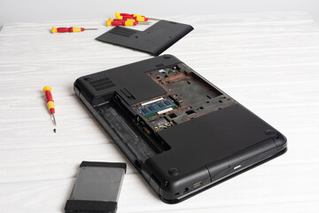 Assembling laptop body on table. Concept of computer repair