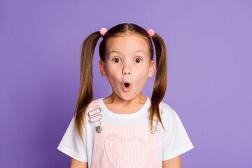 Photo of astonished pretty girl wear pink overall dress unexpected news isolated on blue color background