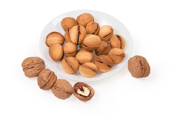 Nuts shape cookies with caramel filling on dish, real walnuts