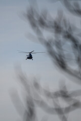 Flying big helicopter over the trees.