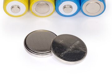 Lithium button batteries against batteries other type close-up