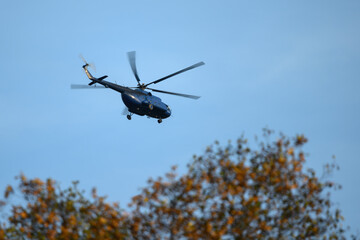 Flying big helicopter over the trees.