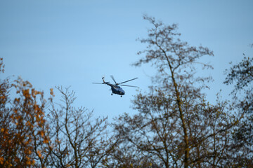 Flying big helicopter over the trees.