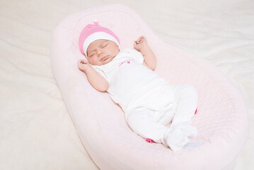 Cute, small and adorable newborn baby girl sleeping