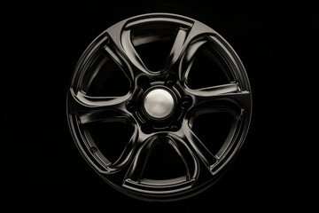 Obraz premium matte black alloy wheel, close-up front view. Powerful wheel for off-road vehicles