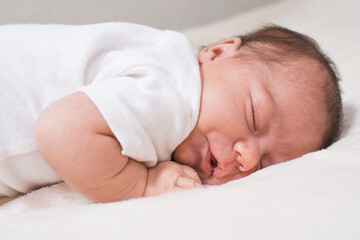 Cute, small and adorable newborn baby girl sleeping