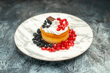 front view little delicious cake with chocolate and raisins on light-dark background sugar cookie biscuit dessert sweet