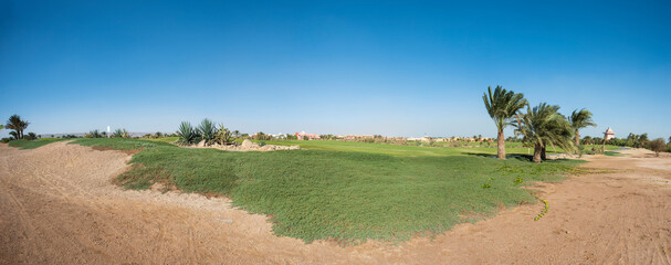 Fototapeta na wymiar Panoramic view across golf course in landscaped tropical resort