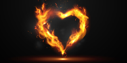 Heart shaped sparks floating on a black background and with flames