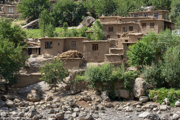 Fototapeta premium Remote traditional Afghan village in the Panj river valley, taken from Darvaz district in Gorno-Badakshan, the Pamir mountain region of Tajikistan