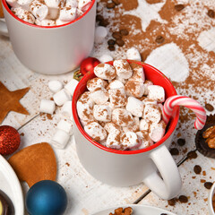sweet food top view background for merry christmas or new year holiday decoration - chocolate candies, tangerines, cookies, marshmallow and cocoa latte on white wood