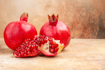 front view fresh red pomegranate on light background red color photo mellow fruit