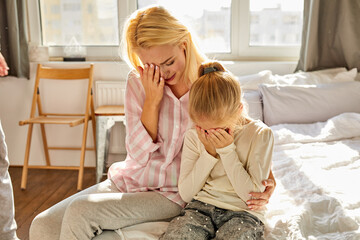 woman and kid girl sit suffering from cruelty of father, abusive relationships concept, man is...