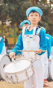 Kids Playing Music In Marching Band, Cute Asian Child Hitting Drum Instrument On Sport Day In School