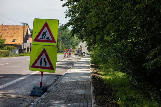 Warning of the road works ahead. Reflection traffic signs telling the drivers the road is going to be narrow