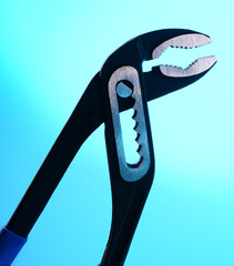 blue background. Adjustable wrench tool. professional maintenance concept. Repair and water pipe renewal. Elimination of plumbing leak. New fix tool for repairman