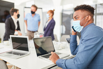 Fototapeta premium Business man with face mask talking on the phone