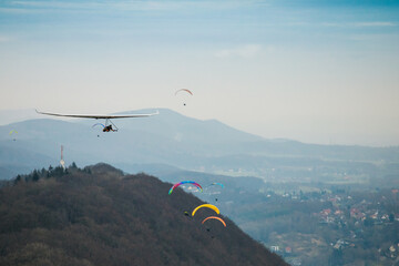 Hang glider in the air on a sunny day.
