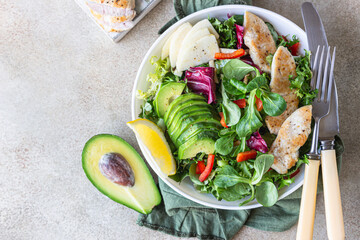 Avocado, apple, bell pepper and grilled chicken salad with ingredients for making salad. Paleo and keto diet. Yop view.