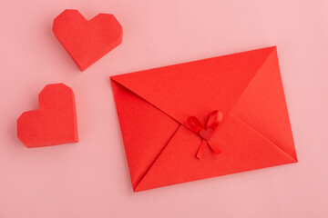 Red paper hearts and envelope with love letter