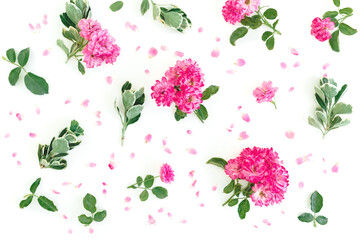 Floral pattern of pink roses flowers and green leaves on white background. Flat lay