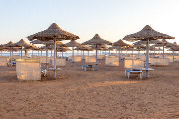 Sunrise on the beach with parasol overlooking the Red Sea in Hurghada, Egypt