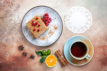 top view yummy cake slice with tea and berries on a light background cake biscuit sweet