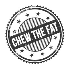 CHEW THE FAT text written on black grungy round stamp.